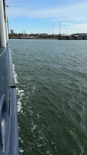 Ferry side view over choppy Klaipeda harbor water