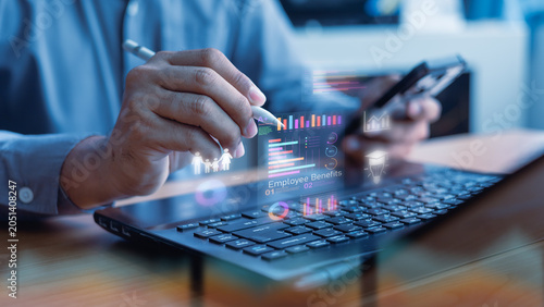 Bild auf Leinwand Business professional reviewing employee benefits and compensation data on a digital dashboard, highlighting workforce welfare, insurance coverage, and revenue growth insights