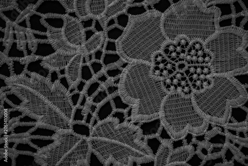 Φωτογραφία Intricate floral lace design on black fabric with detailed stitching and small p