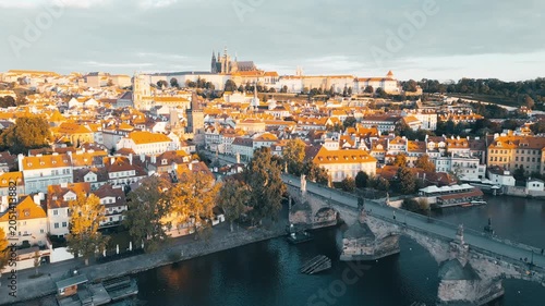 Experience the breathtaking views of Charles Bridge and Prague Castle from above. This aerial journey highlights the beauty of Prague in the morning light over the Vltava River.