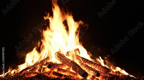 Blazing campfire, burning wood, flames at night, outdoor fire