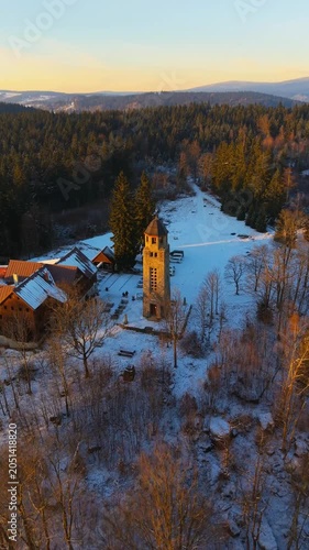 Explore Bramberk lookout tower in the Jizera Mountains during winter. Discover the snowy landscape and take in the views from the tower. Nature and history combine at this location.