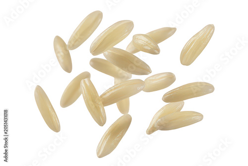 A collection of raw uncooked long grain rice grains scattered against a solid black background, showing texture and shape