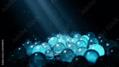 Glowing blue spheres and orbs scattered in darkness with light rays