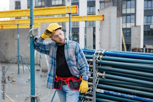 Construction worker feeling tired at building site