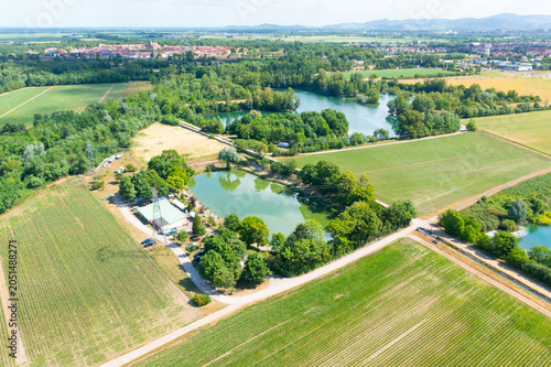 Drone photograph of recreational fishing ponds and agricultural fields in a rural landscape. Aquaculture, recreation and countryside concept
