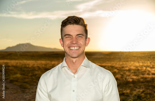 Smiling man outdoors at sunset