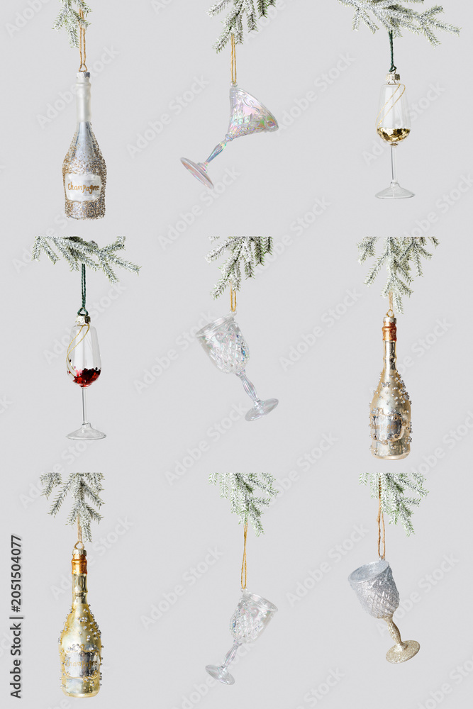 Fototapeta premium Minimal creative aesthetic photo of toy bottles and wine glasses of sparkling drinks hanging on snow fir branches on neutral fon. Concept of surrealism, celebration, winter holidays festive xmas drink