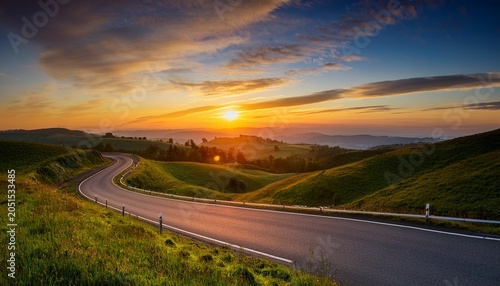 sunrise journey a winding road disappears into a vibrant sunrise over rolling hills symbolizing a path towards new beginnings and endless possibilities