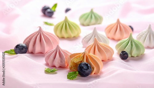 Artfully Placed Fruit Infused Meringues in Pastel Colors with Fresh Blueberries and Mint