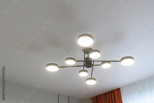 Bild auf Leinwand modern matte black ceiling chandelier with eight round LED lights arranged in a