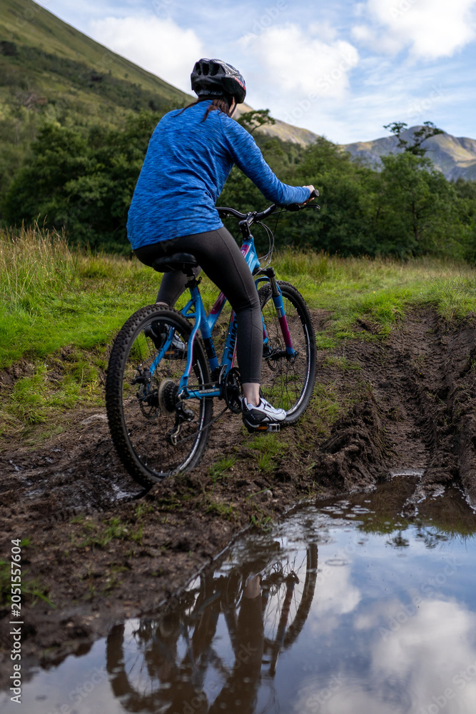 Fototapeta premium Cyclists exploring muddy mountain trails.