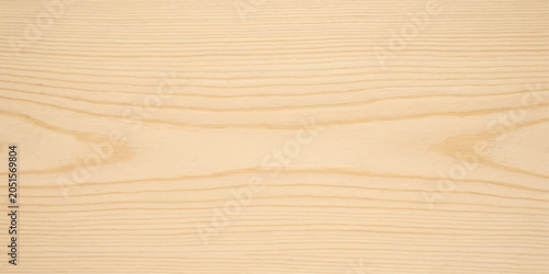 Close-up view of light-colored wood grain texture, showcasing natural patterns and smooth surface.