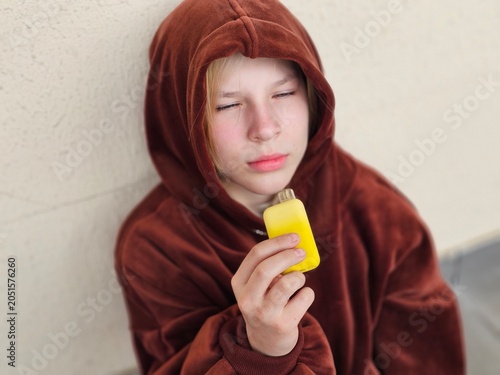 Quadro su tela A teenager smokes an e-cigarette concept