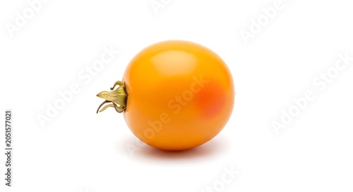 Single ripe yellow tomato isolated on white background
