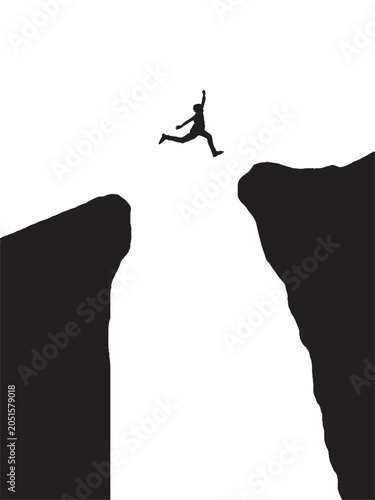 Photos A person leaping across a chasm between rocky cliffs depicted as a stark black s