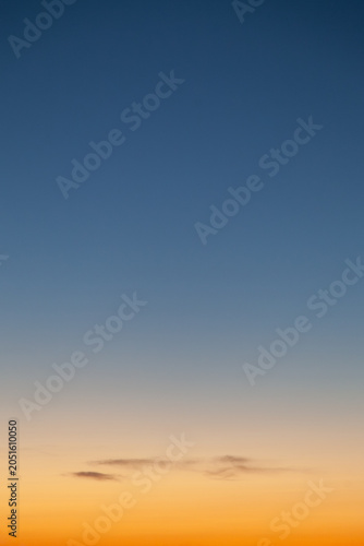 Clear and empty blue and yellow orange gradient sky for background, vertical image