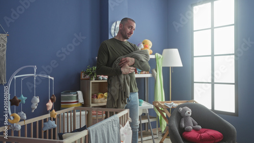 Billede på lærred Man holds baby in cradle with hand supporting head, gazing toward window in baby room building; quiet bonding tenderness