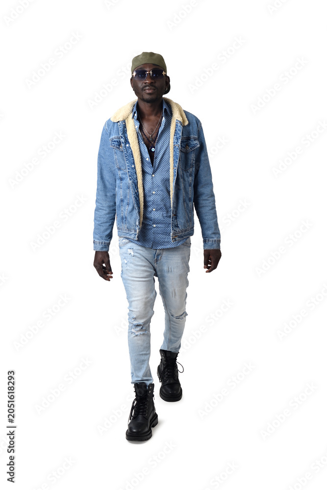 Fototapeta premium Portrait of a young man in street clothes from front view walking on a white background.