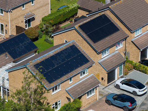 Aerial view of modern detached houses fitted with rooftop solar panels in a residential neighbourhood near Acomb York North Yorkshire highlighting renewable energy adoption and sustainable living