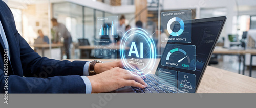 Close-up of a businessman in a suit using a laptop with an AI interface displaying data analytics, process automation, and efficiency metrics in a modern office setting with soft natural light