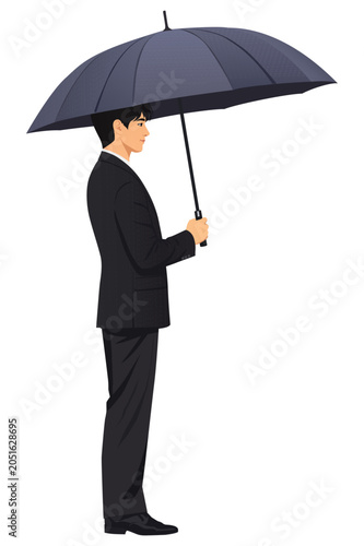 Businessman standing in profile holding black umbrella isolated on light background representing protection security and risk management
