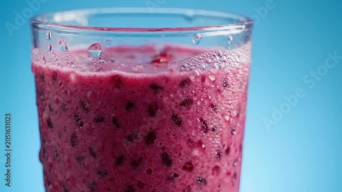 Fresh Mixed Berry Smoothie in Glass with Frozen Fruits and Creamy Texture on Bright Background