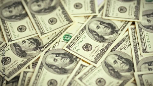 A smooth top-down sweep over a spread of vintage dollar bills highlights a paper-money concept, providing a financial backdrop for business and advertising visuals, emphasizing economic themes