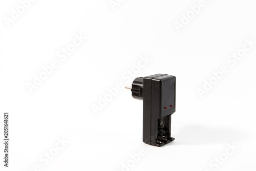 A vintage black wall plug-in NiMH battery charger for AA and AAA batteries isolated on a clean white background