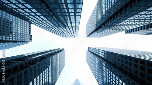 Symmetrical skyscraper tops framing a white sky.