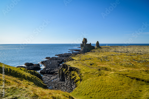 Volcanic basalt sea stacks on a mossy coast