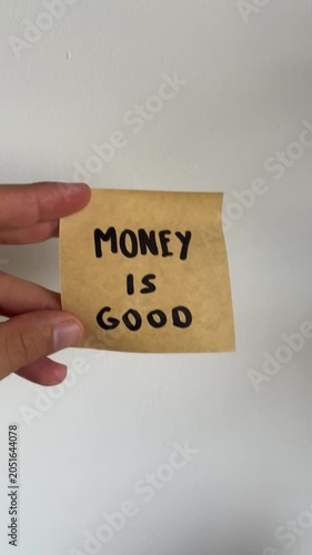 Hand holding sticky note with 