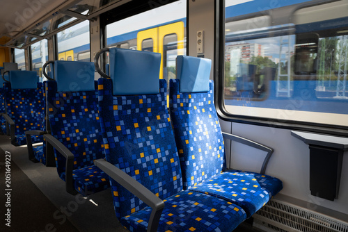 Schilderij op canvas Empty commuter train interior with modern blue passenger seats