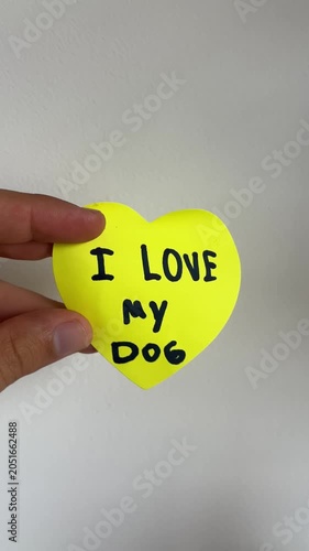 Hand holding yellow heart sign with 