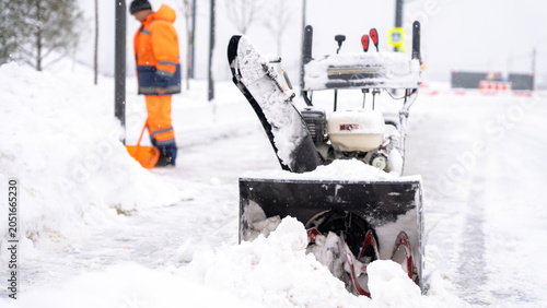 Snowy street clears with mechanical snow plow
