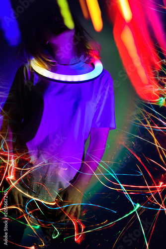 Very nice young woman on music community event bokeh background. Young girl dancing over disco club color lights