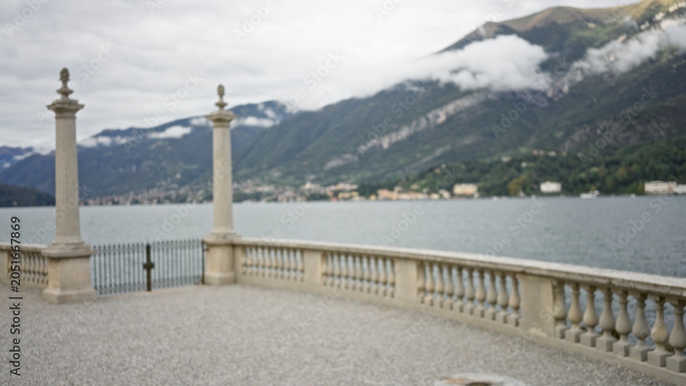 Obraz premium Lakeside terrace with stone balustrade, soft defocused bokeh background, outdoor; background backdrop copyspace calm.