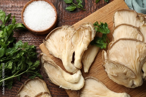 Bild auf Leinwand Fresh oyster mushrooms, salt and parsley on wooden table, flat lay