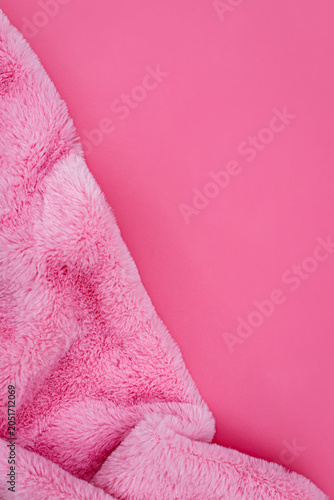 Soft pink blanket rests on a simple pink background during indoor activity time at home