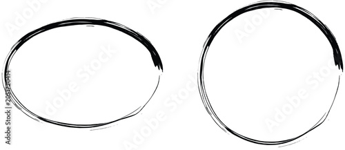 Two metal hoops are lying on a plain white surface side by side