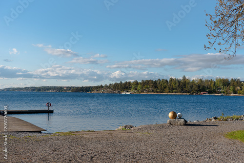 scenic lakeside view with wooden pier and blue sky