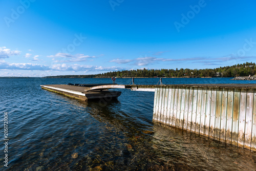 scenic lakeside view with wooden pier and blue sky