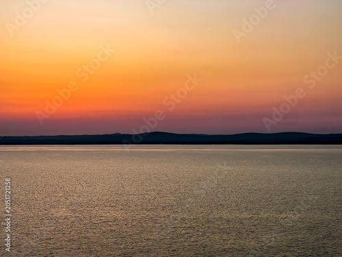 Sea of Marmara Turkey - July 21, 2024: Sunset with tiny blinkering lights on shoreline
