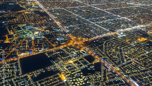 RIYADH, SAUDI ARABIA - JUNE 1, 2026: High altitude aerial view of Riyadh city at night showing illuminated street grids and highway interchanges from an airplane window