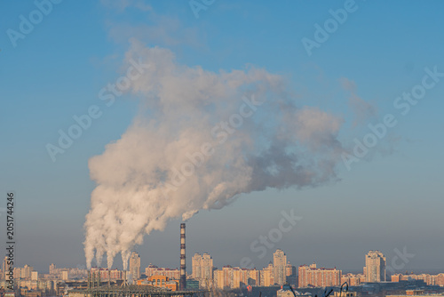 Quadro em tela Cityscape with industrial facility at dawn or dusk, gray buildings, multiple lev