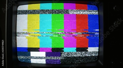 Vintage television screen with colorful static and test pattern on display clearly