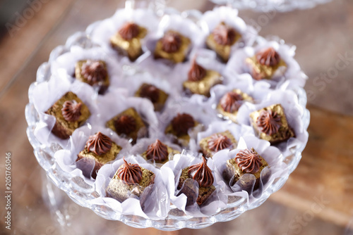 Gourmet Chocolate Camafeu Sweets with Gold Dust and Ganache on Luxury Crystal Tray