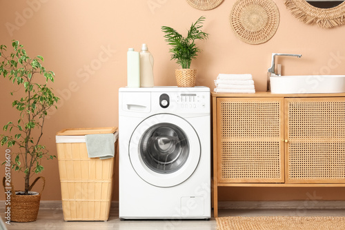 Bild auf Leinwand Interior of laundry room with washing machine, basket and sink