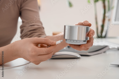 Woman connecting sound spea...