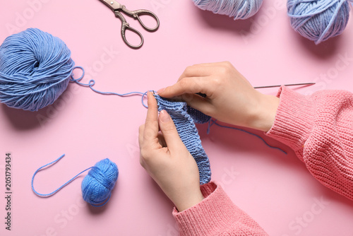 Woman knitting clothes on p...